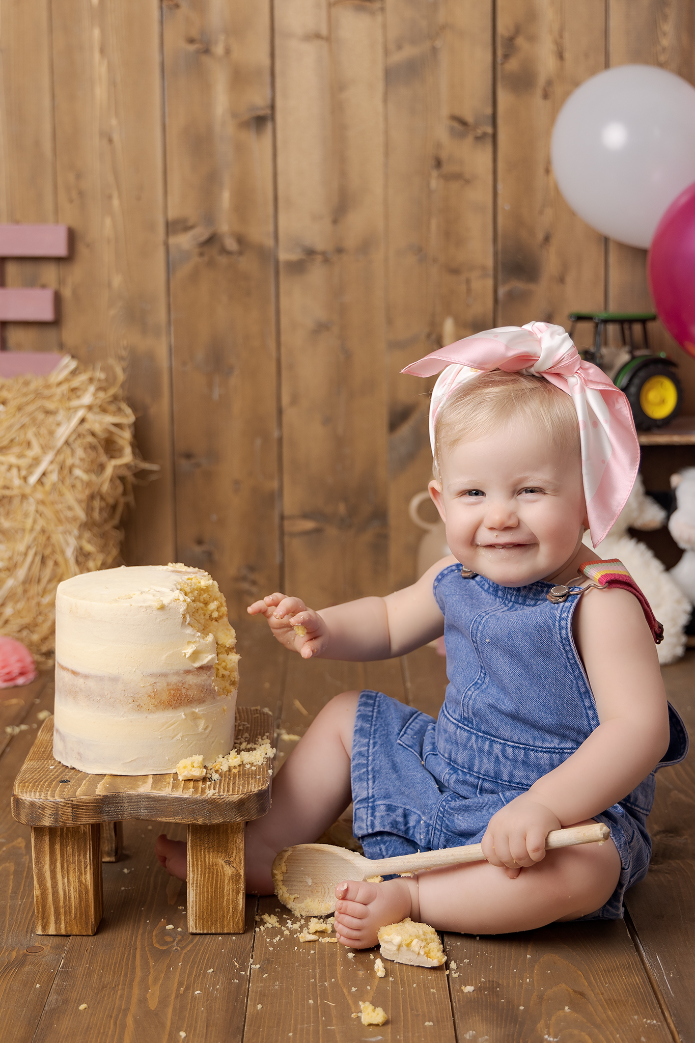 Farmyard theme girl's cake smash, little girl giggling and having fun during her cake smash in Sutton Coldfield birmingham